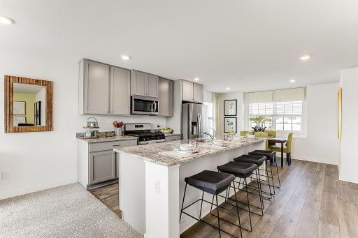 With a gas range, vented microwave fan, and large entertaining island, this kitchen is a chef's dream! *Model home, colors and selections will vary.