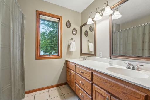 The upper level of the home has this full bath complete with a large vanity with dual sinks plus a linen closet.