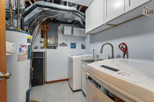 Laundry area and mechanicals are located on the main level of the home. Extra cabinets to store all your laundry needs and a wonderful laundry sink too.