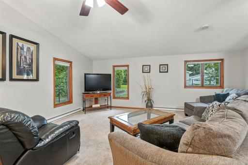 The living room area has plenty of seating possibilities and is wide open to the dining and kitchen.
