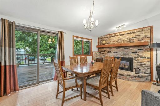 The informal dining area connects both the kitchen and living spaces and opens to the large deck. The gas fireplace is gorgeous and great for those cool nights when you want a little extra warmth.