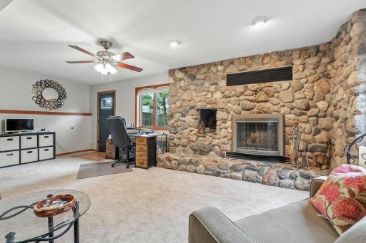 The family room in the lower/main level of the home has this stunning wood burning fireplace.