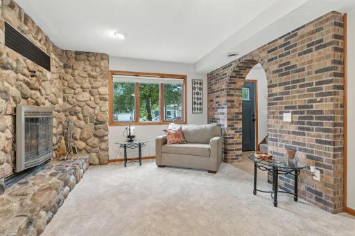 The main level of the home is where the family room is located with this fabulous wood burning fireplace. Also in this room is another entry to the home which opens out to the fenced yard area - perfect for pets!
