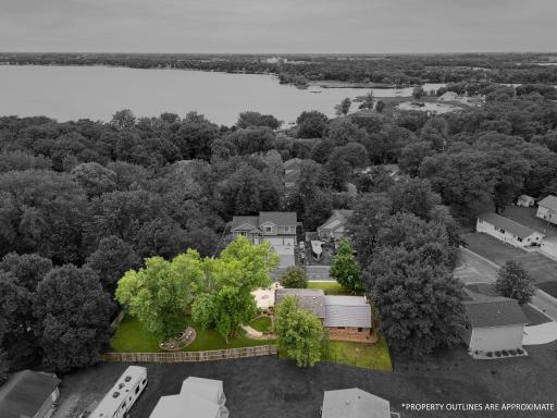 Aerial overview of the home with the property outlines which are approximate.