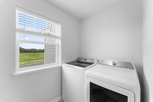 Upper level laundry room includes washer and dryer.
