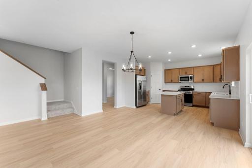 The dining area provides convenient access to both the upper level and mud room. The mud room is thoughtfully situated near the main-level bath, flex room, and spacious 3-car garage.