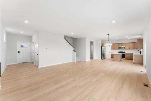 The welcoming entry flows seamlessly into the family room, dining area, and kitchen, creating an open and inviting main level.