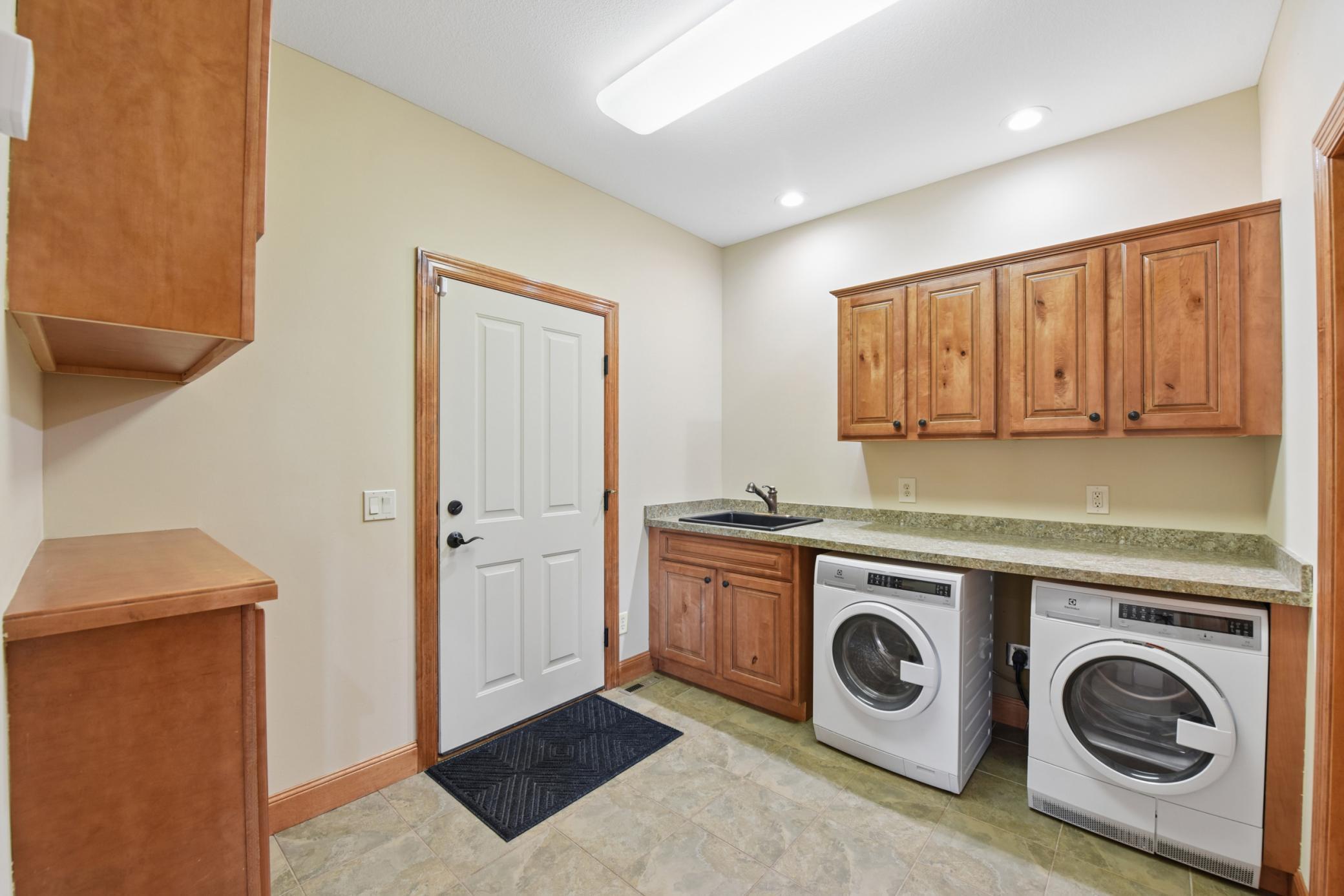 Laundry room/mud room off of kitchen to garage has great space, storage, and a closet.