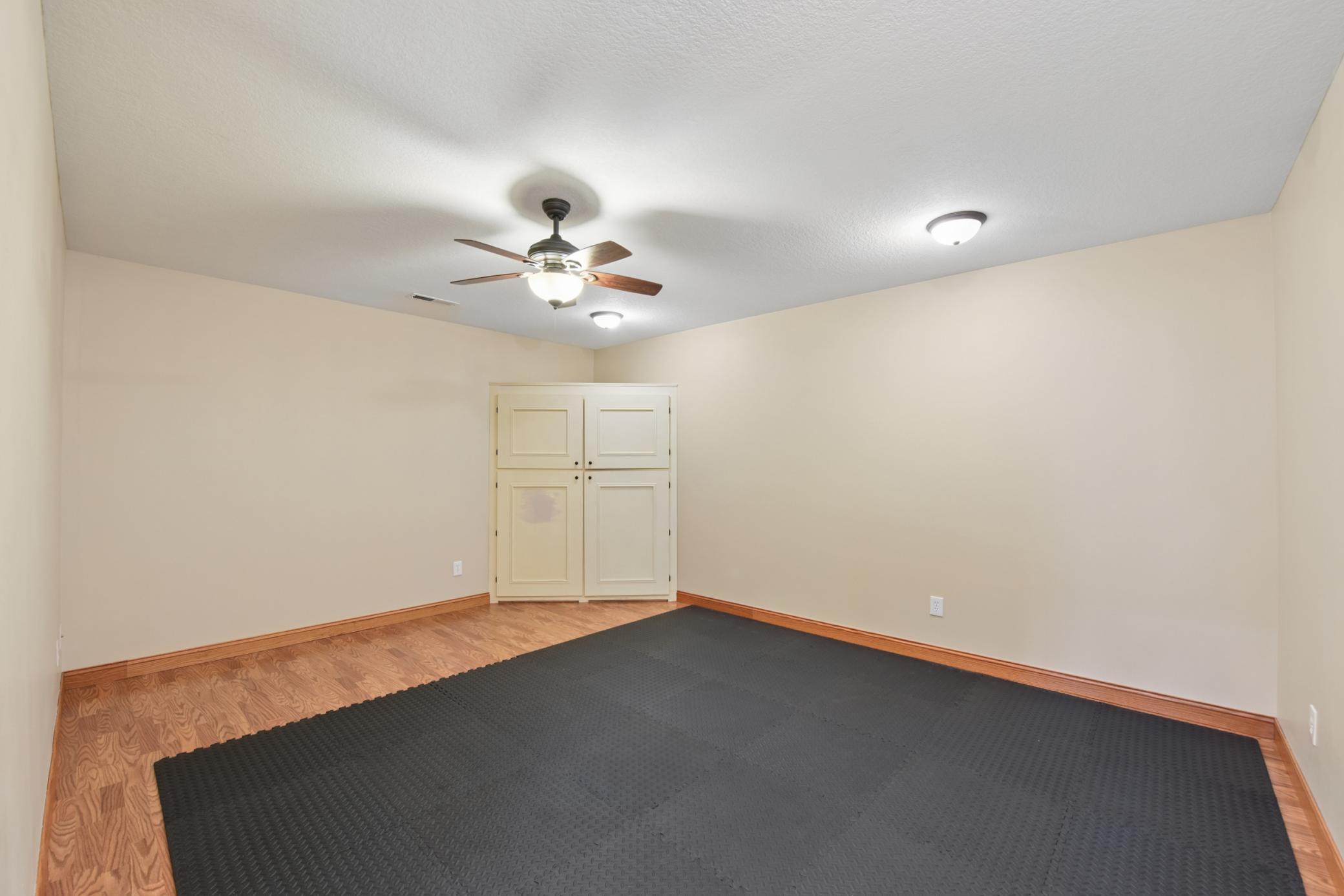 The utility room on the lower level has served as a workout space and craft area previously.