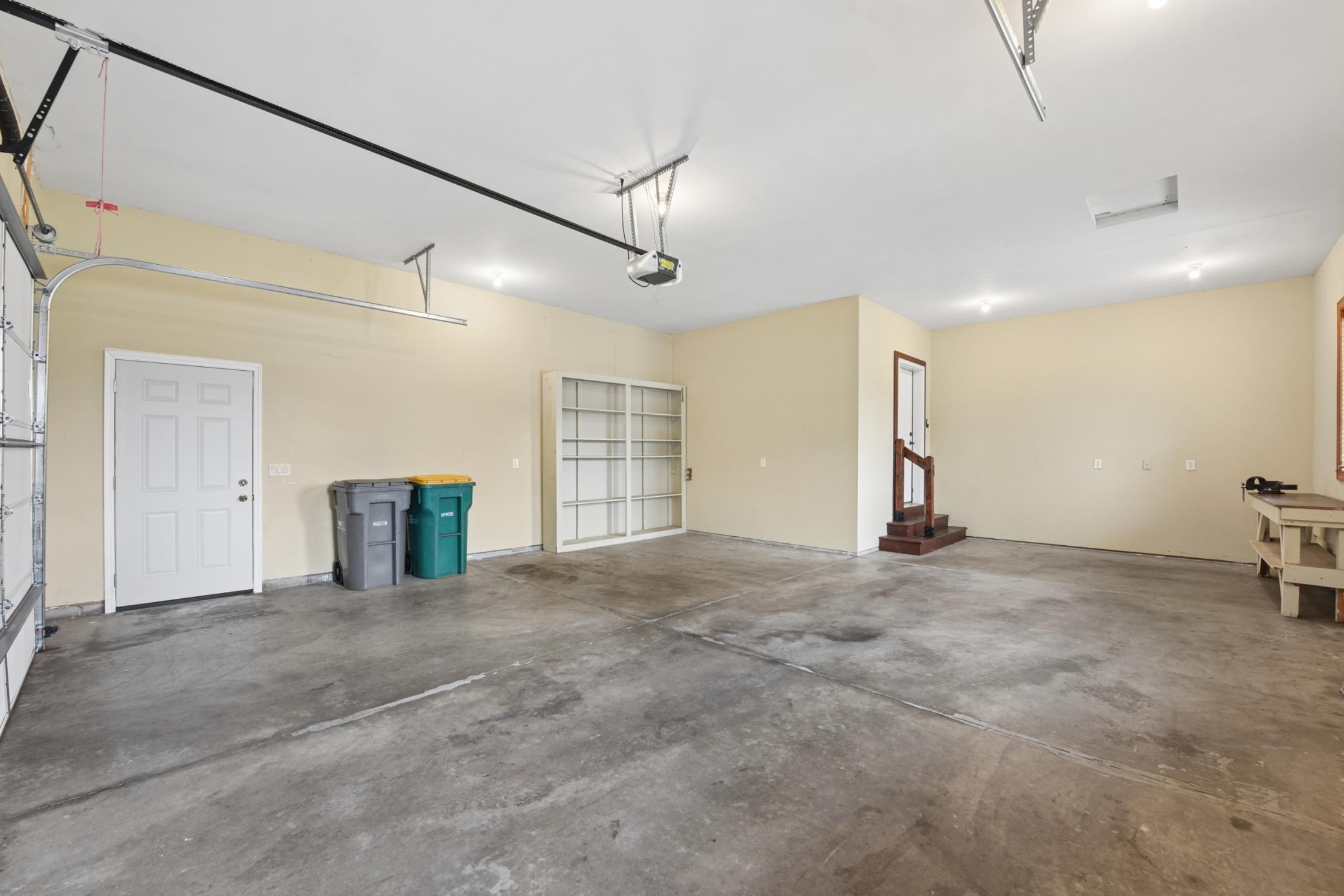 The two car garage has extra space in front, which could be used for storage of yard equipment or even a ramp for accessibility if you want.