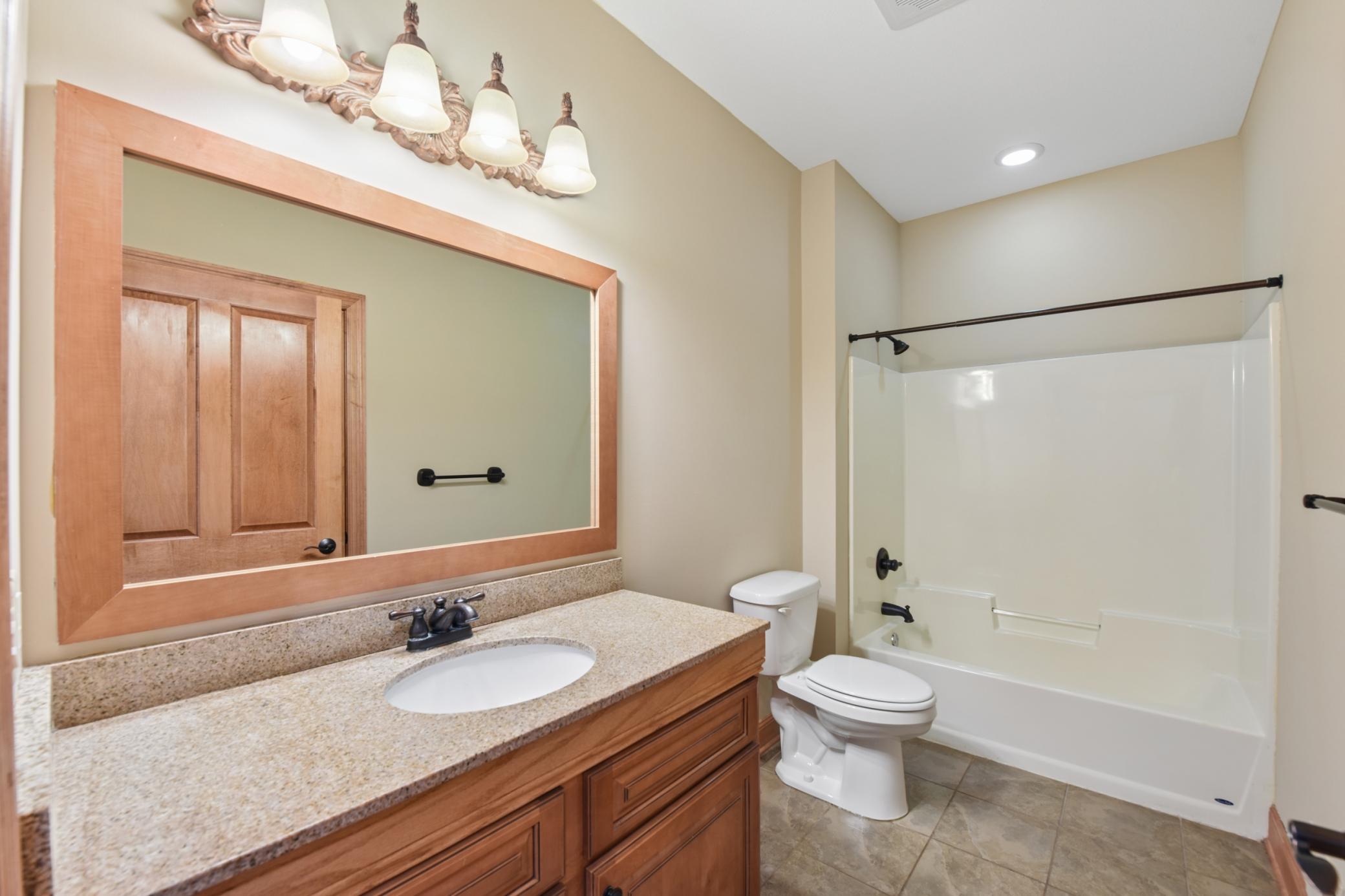 Full bath off of the front hallway and near the office and kitchen.