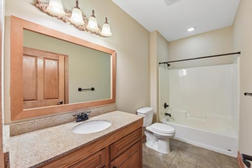 Full bath off of the front hallway and near the office and kitchen.
