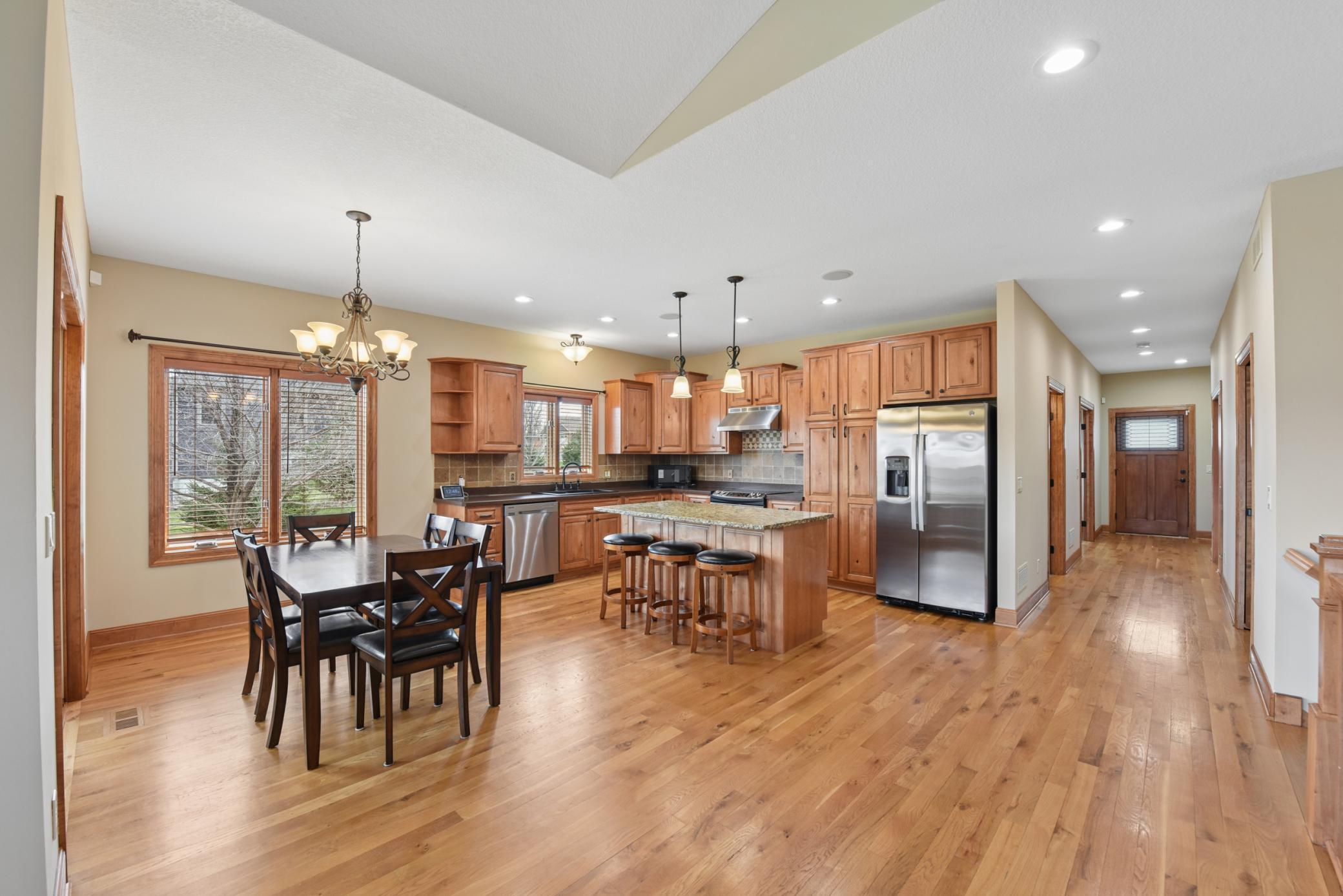 Hardwood floors, newly stained cabinets, and stainless steel appliances make this a kitchen worth waiting for!