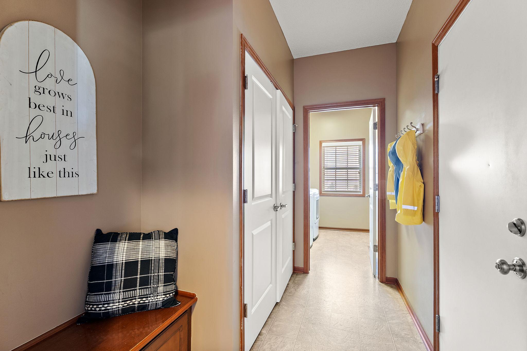 Adorable bench, large coat closet, and hooks for coats.