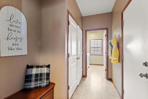 Adorable bench, large coat closet, and hooks for coats.