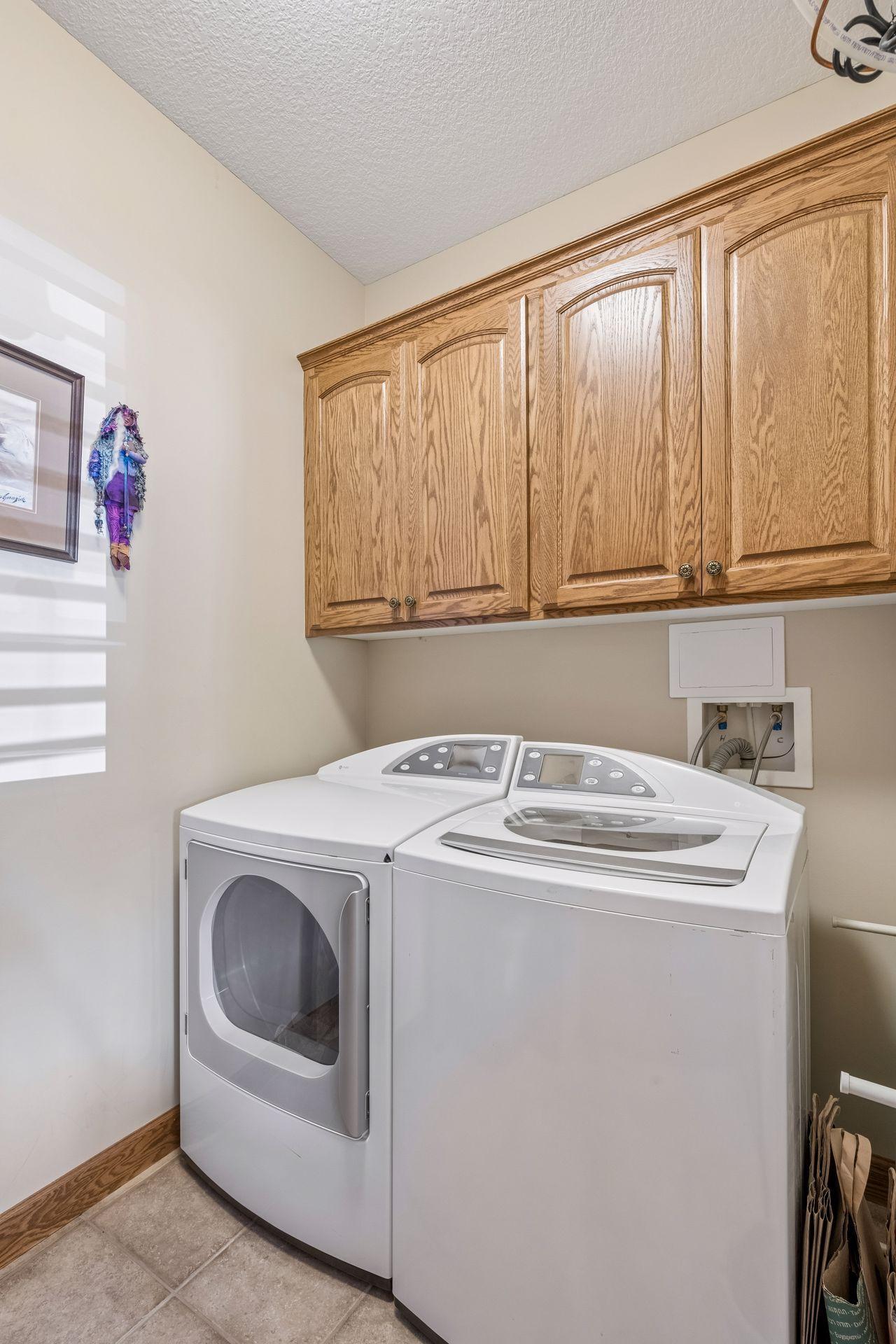 Your private laundry room inside your home with great extra cabinetry
