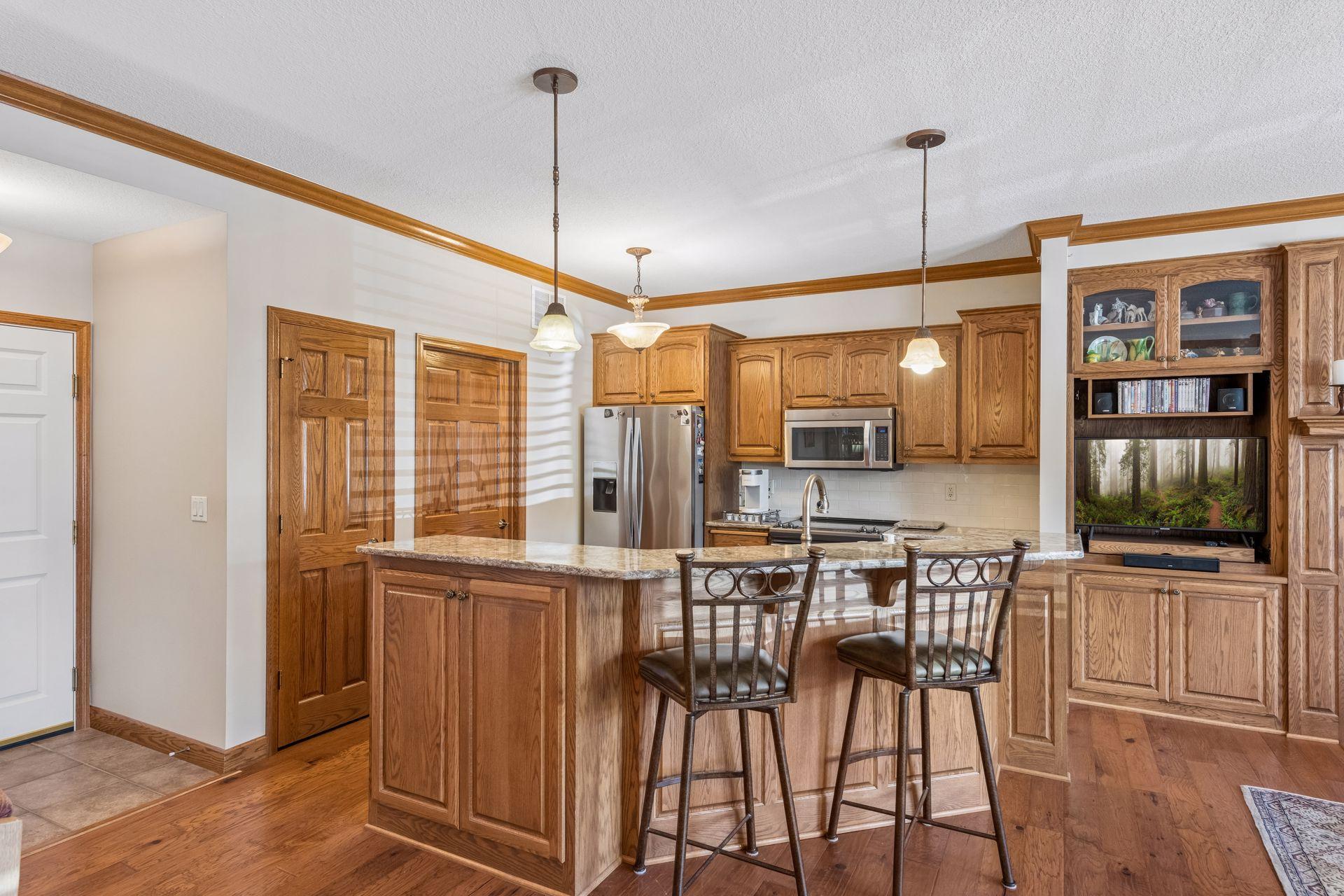 Large kitchen island with two tiers creates so much counter space