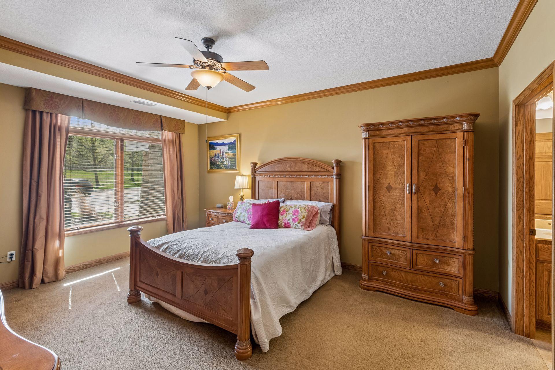 Primary bedroom has ceiling fan, crown molding and lots of room for your furniture