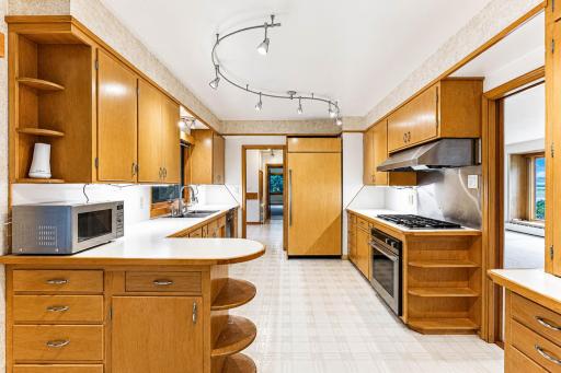 So much storage in the vintage kitchen, with commercial grade range, hood and Subzero refrigerator.