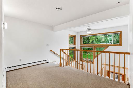 Large upper level landing area with a large window array for extra daylight.