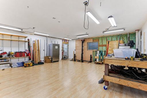 The 25x23 shop on the main level is insulated and could easily be heated. Features an electric lift from the lower level storage room.