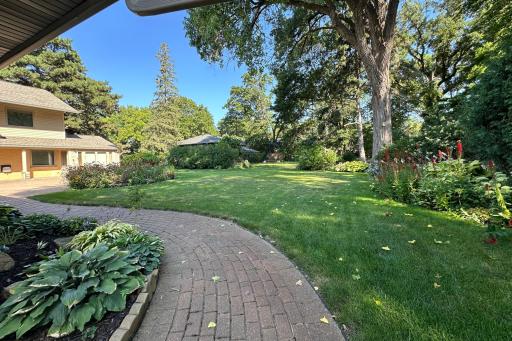 Brick walkway leads to the backyard on the northside of the home.