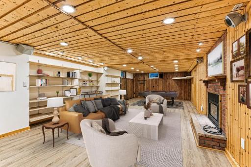 Lower level amusement room with built-in speakers, bookshelves, and fireplace,, 34x16.