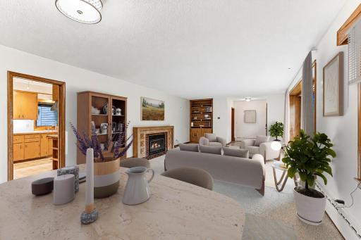Living room has a gas fireplace and built-in bookcase.