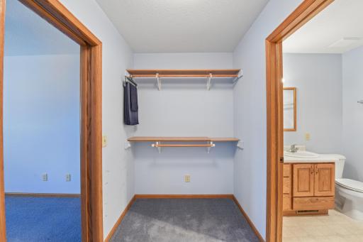 One side of the walk-in closet leading to the bathroom