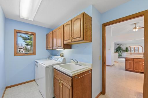 Conveniently located laundry/mudroom just off the kitchen and garage, is complete with cabinets and a utility sink