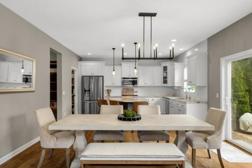 On-trend lighting, subway tile, crisp white cabinetry, and granite countertops all tie the space together with a fresh, cohesive look.