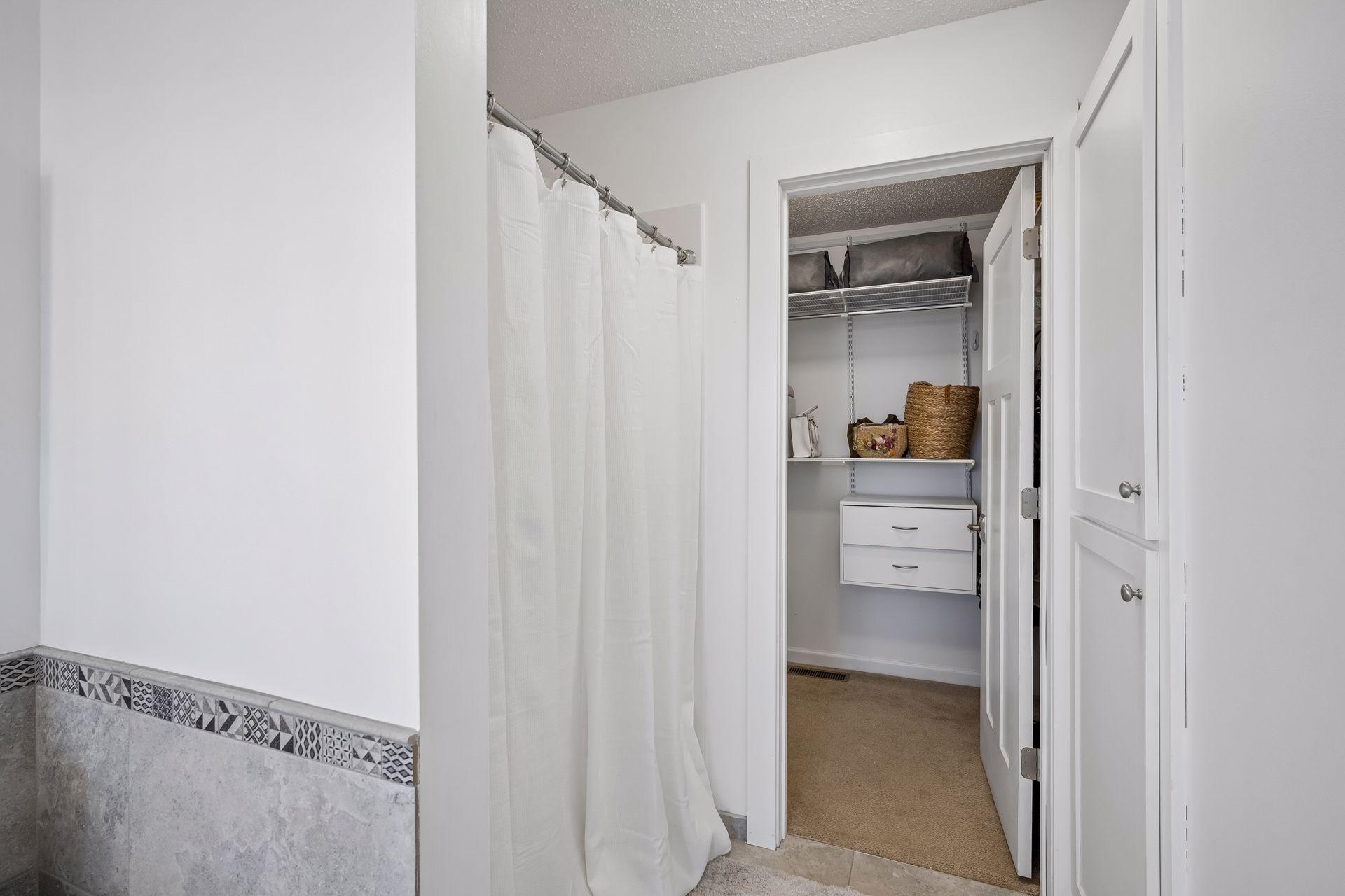 Primary bath walks through to walk in closet