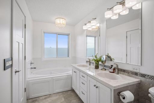 furniture style vanity, large tub and separate shower