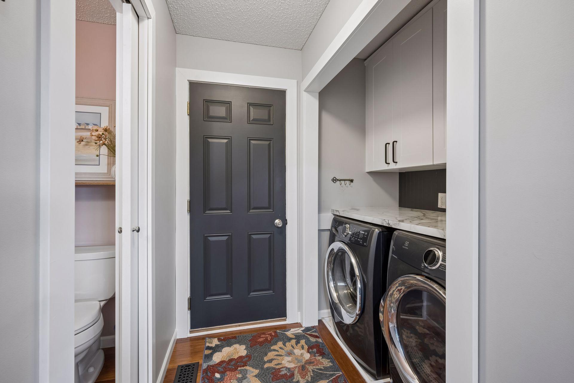 Main level laundry with additional cabinet storage