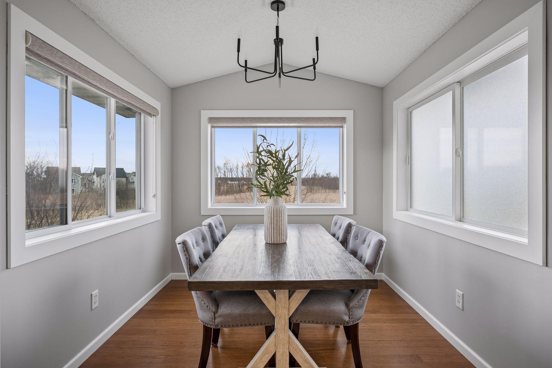 Sunroom makes the perfect dining area updated with fresh paint and a new fixture