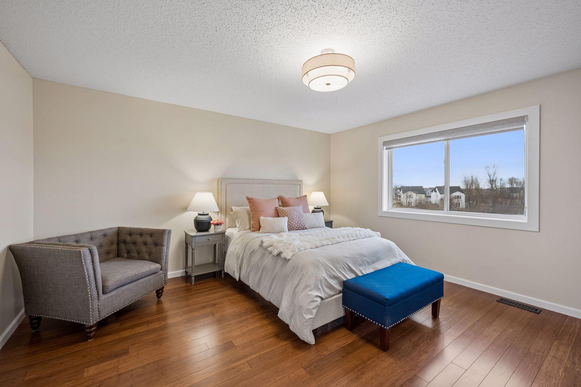 Oversized primary with fresh paint, hardwood flooring and updated fixture