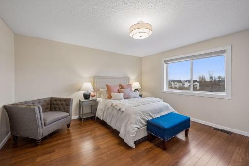 Oversized primary with fresh paint, hardwood flooring and updated fixture