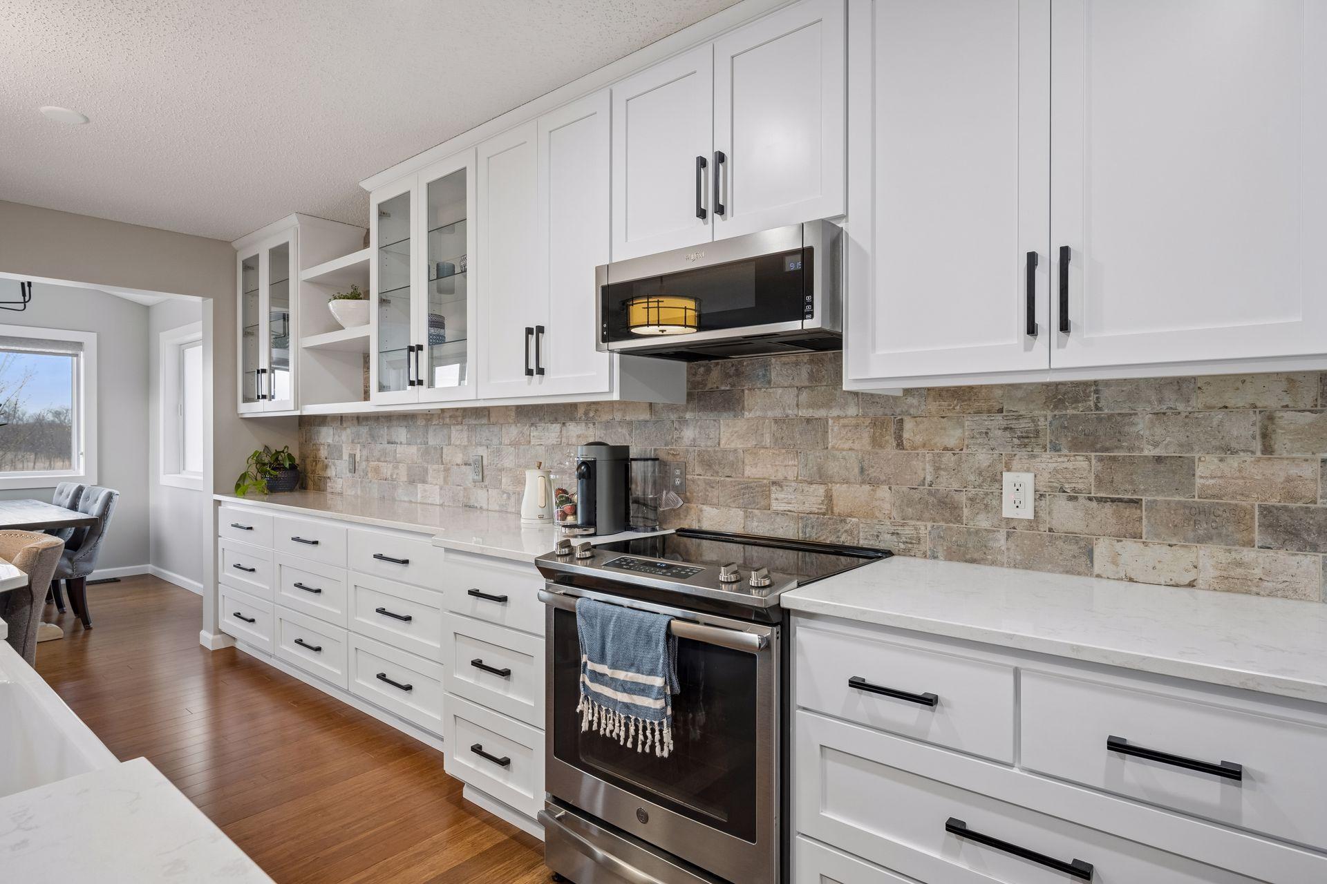 Stone backsplash and plenty of cabinet space