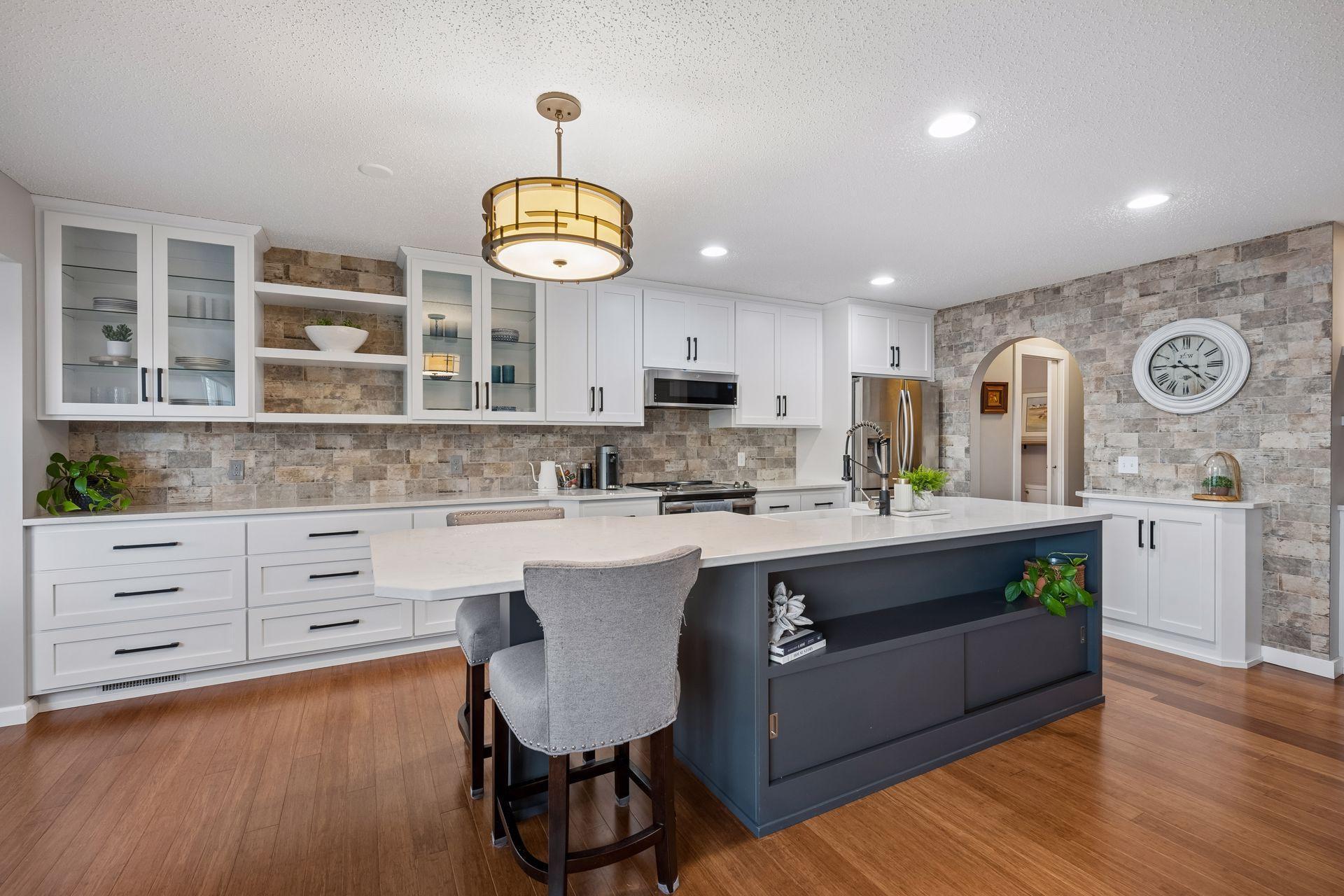 Custom cabinetry, oversized island with storage and room for 2 at the end breakfast bar nook