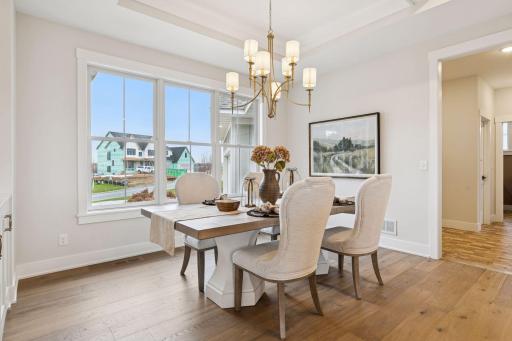 Bright informal dining room with elegant lighting, perfect for everyday meals or entertaining.