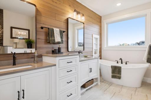 Stunning private primary with dual sink vanity and luxurious soaker tub