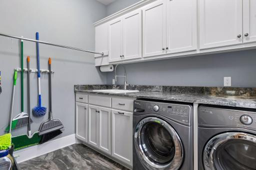 Spacious laundry room with a sink and lots of countertop space