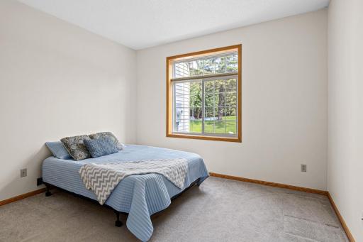 Main floor bedroom is large enough to handle all your furniture! Nice green space view to boot!