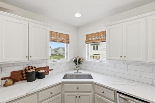 Bright and sunny kitchen with windows and custom blinds.