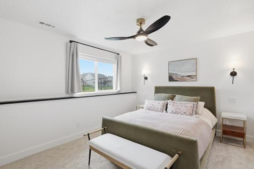 Lower level bedroom with mounted lights that are hard-wired with convenient switches.