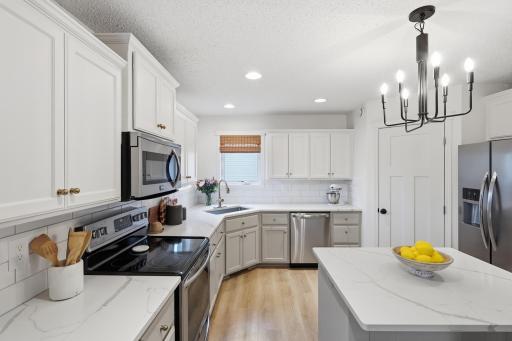 Kitchen with updated sink and faucet. New hardware and light fixtures.