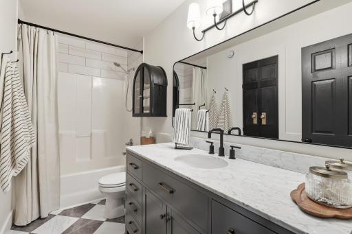 Full bathroom on upper level with luxury vinyl tile, extra long vanity, and additional updates throughout. Convenient linen closet.