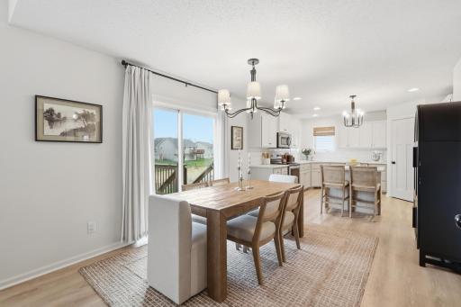 Spacious dining area with sliding glass door to the deck, open to kitchen and great room.