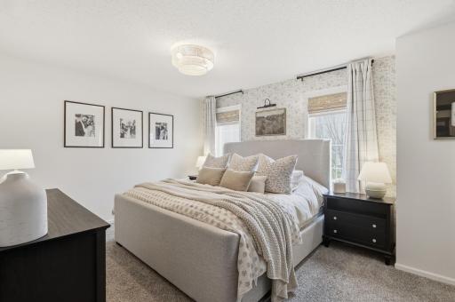 Spacious primary suite with private full bathroom and walk-in closet.