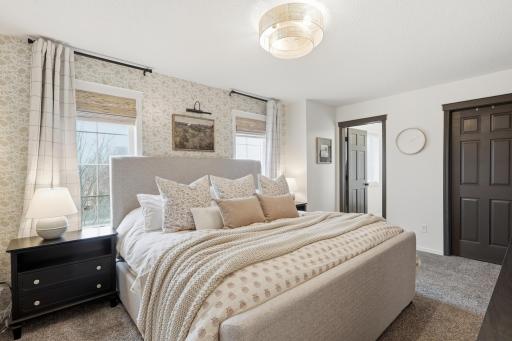 Primary suite with walk-in closet and private full bathroom.